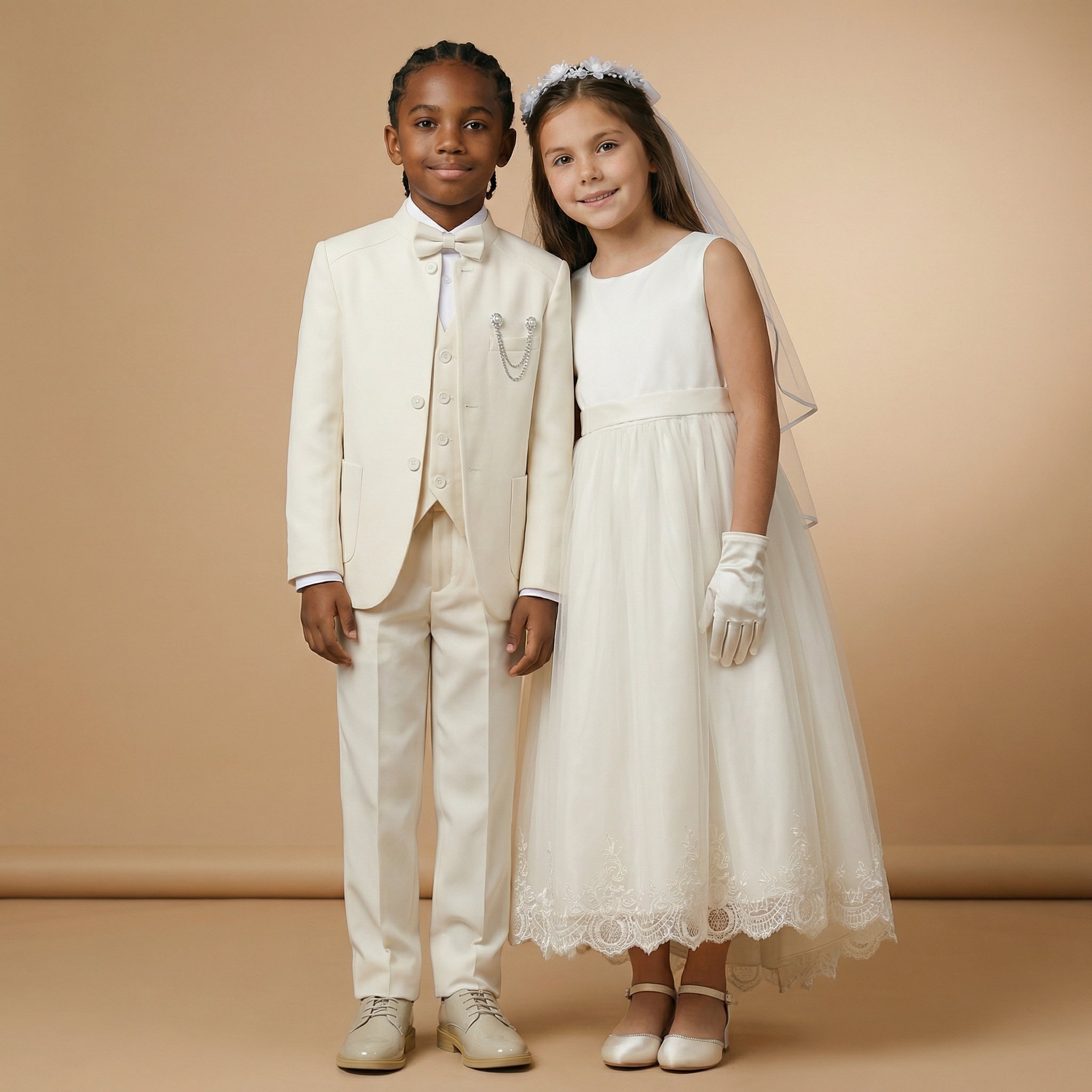 A boy and girl wearing communion outfits posing sweetly together.