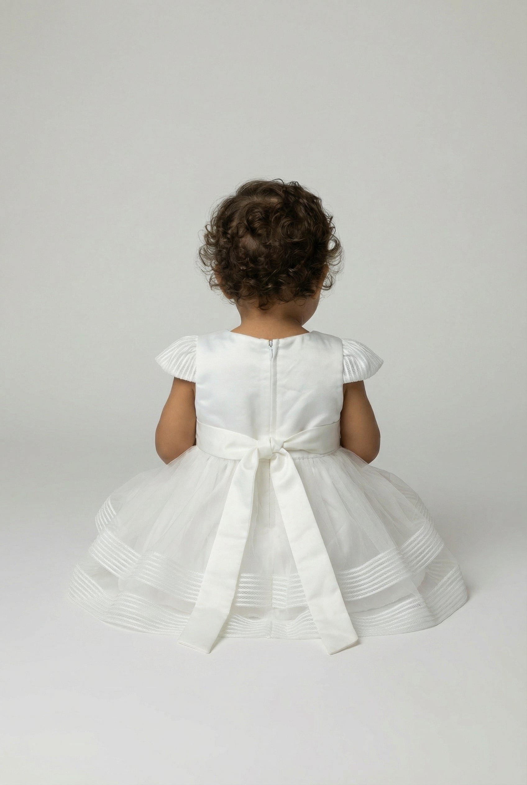 Vestito per bambina in tulle avorio con fiocco in raso in vita