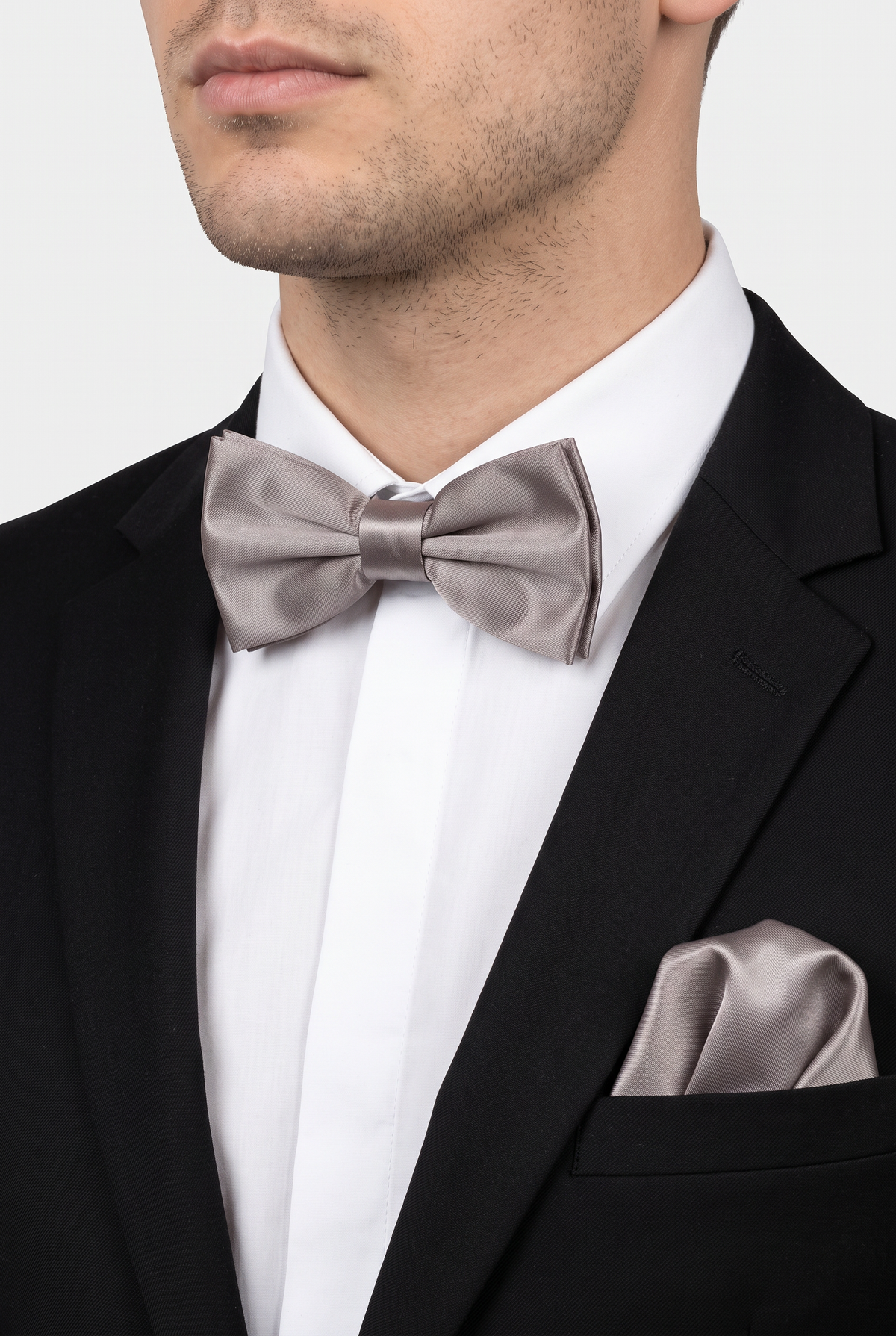 Men wearing a dark silver satin bow tie and matching pocket square with a suit