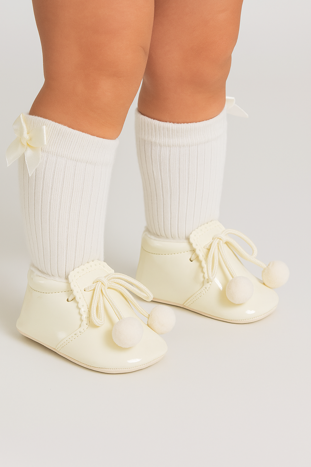 Unisex Baby Patent Pom Pom Booties Pram Shoes - Joe - Ivory Model Picture