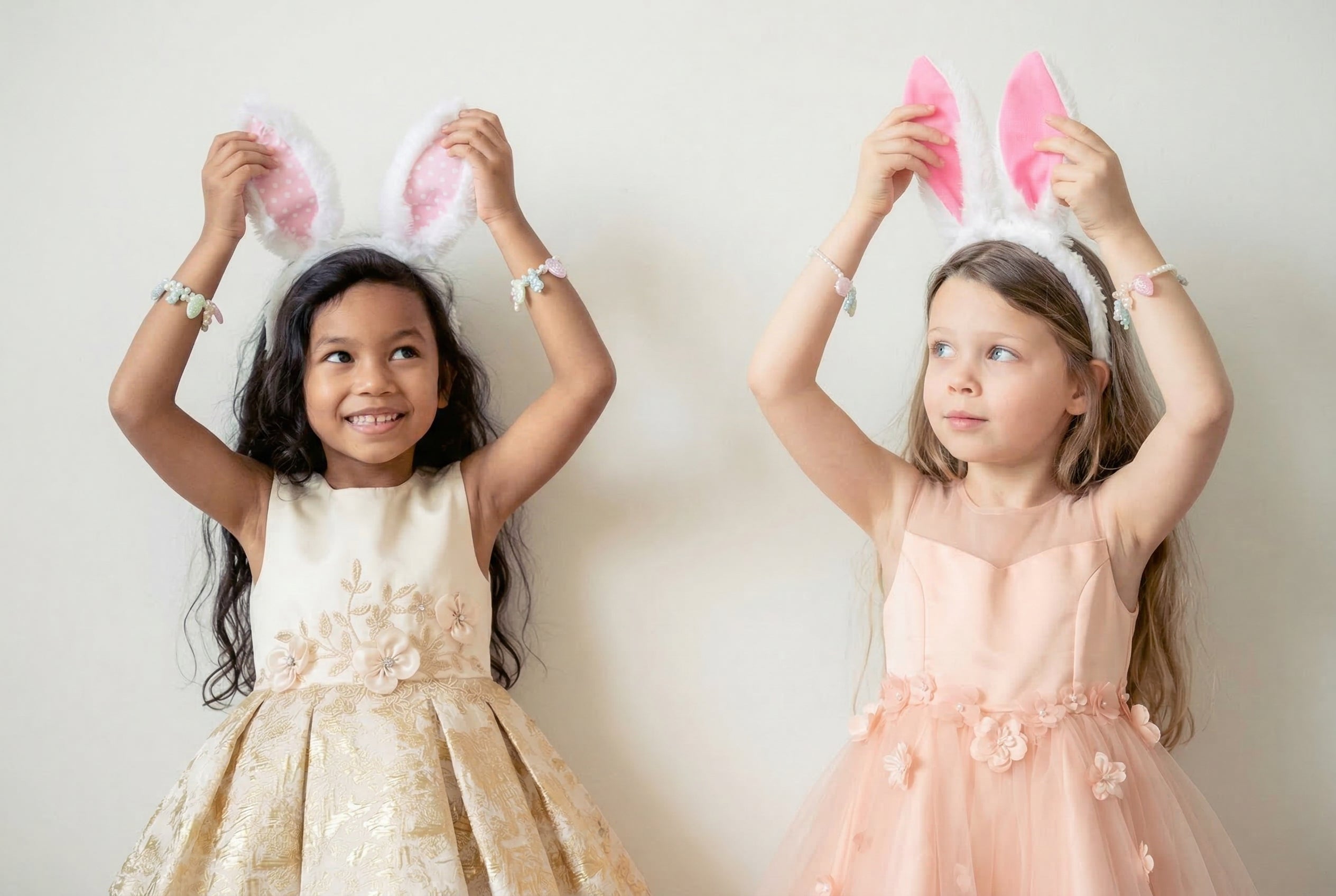 Two girls wearing Easter bunny ears showcasing their Easter dress outfits.