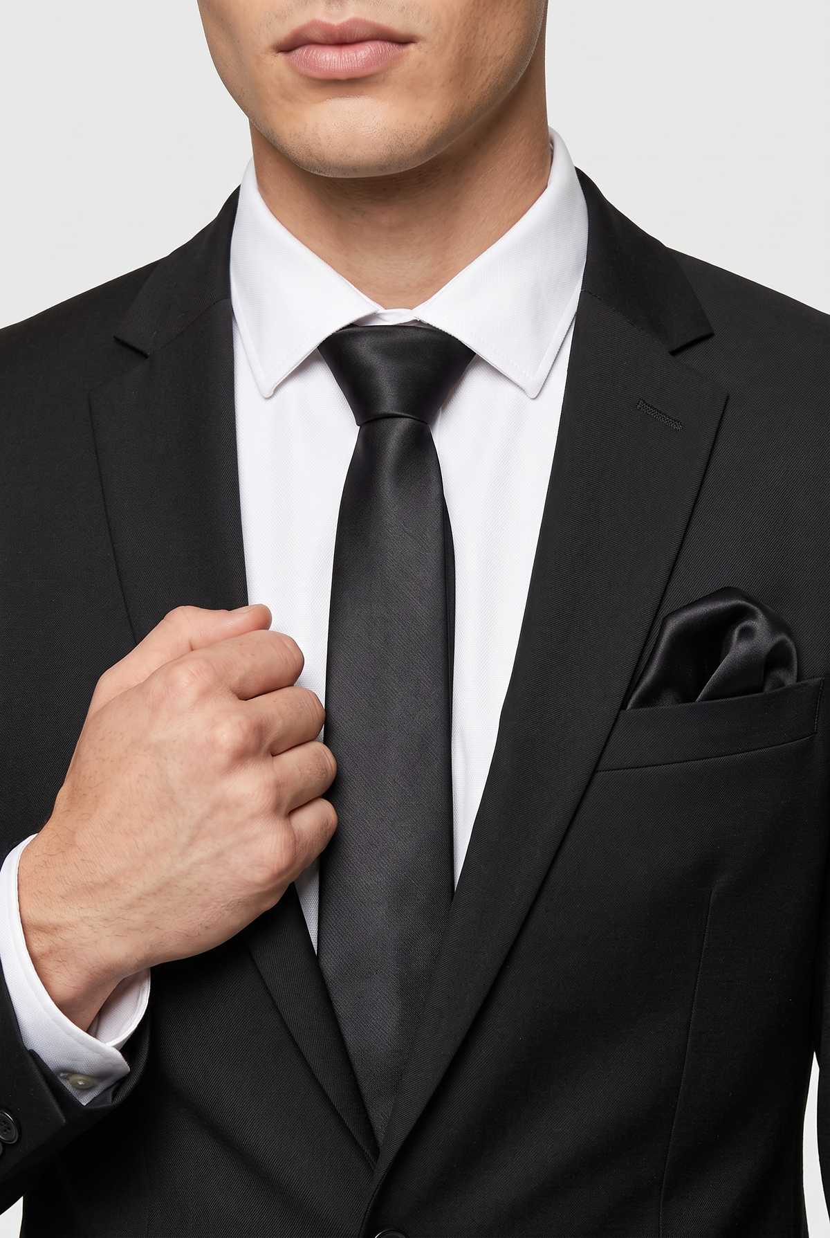 Black int satin tie and pocket square styled with a black suit