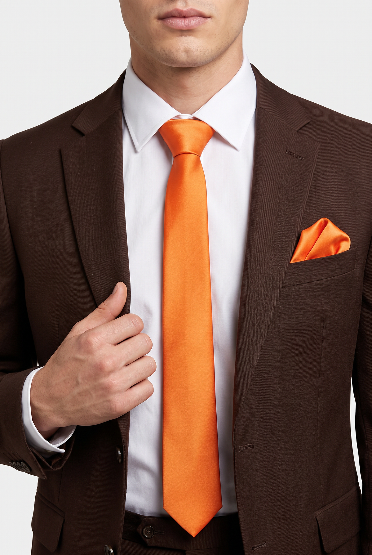 Orange satin tie and pocket square styled with a brown  suit