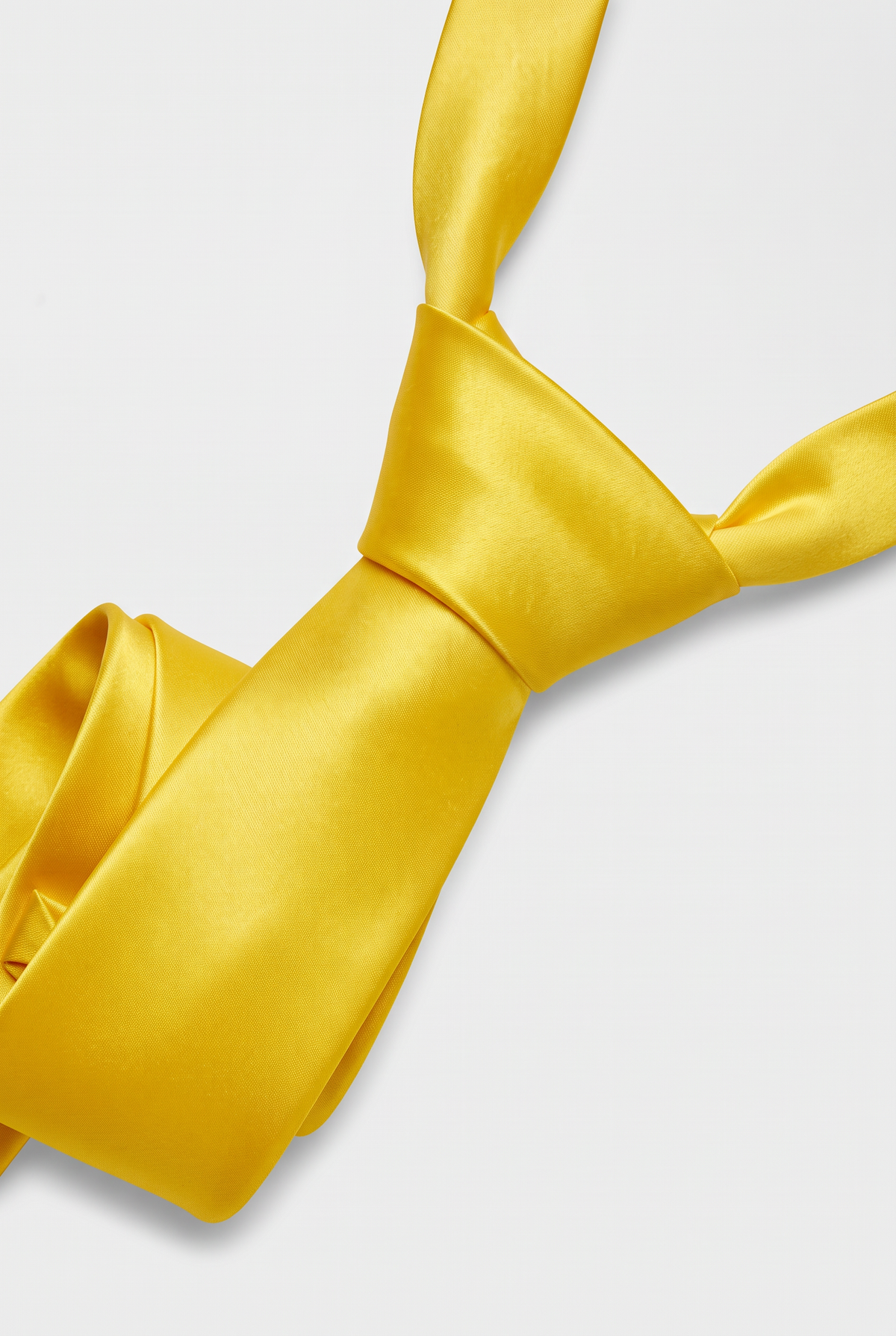 Yellow satin necktie showing knot and fabric texture close-up